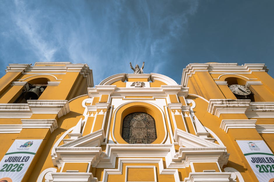 Vibrant yellow facade of Trujillo Cathedral with clear blue sky backdrop. Iconic landmark in Perú.