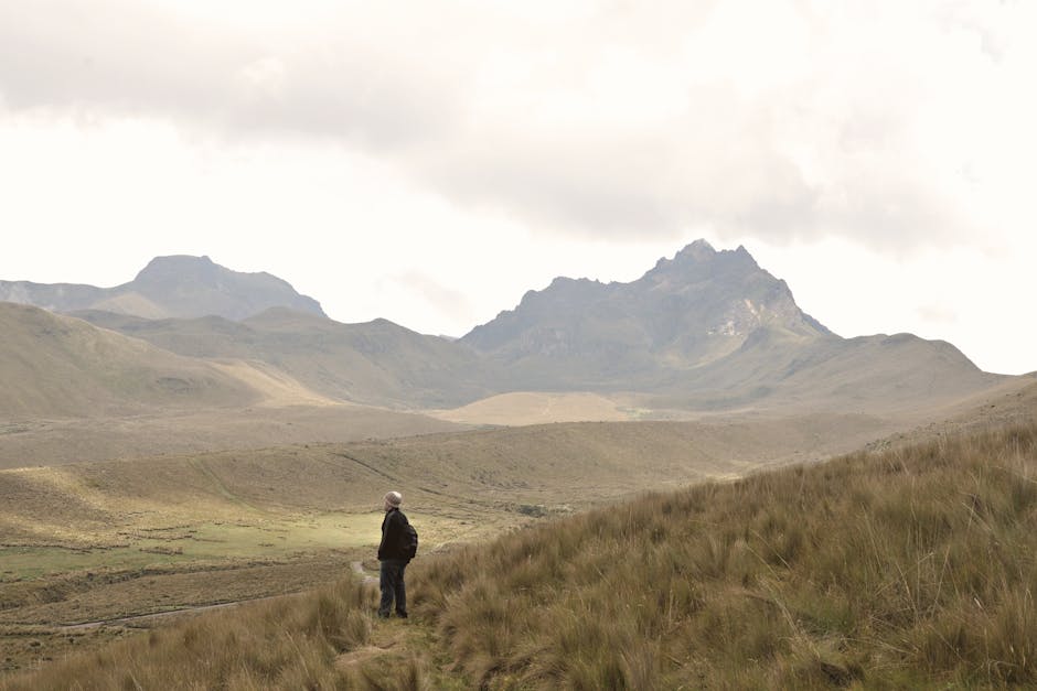Solitary hiker explores the vast Andean mountains in Ecuador with dramatic scenery.