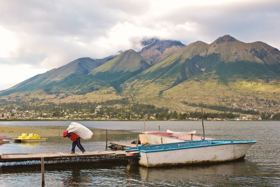 Tranquil lake scene with mountains in Ecuador, featuring scenic views and cultural elements.
