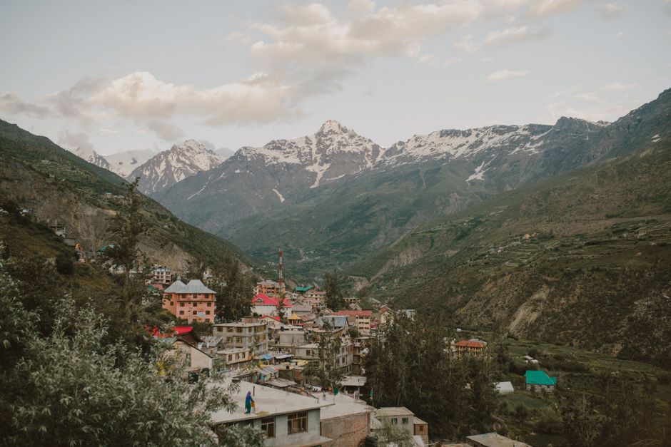 From above of small residential buildings located on mountain slope in Manali resort town in India