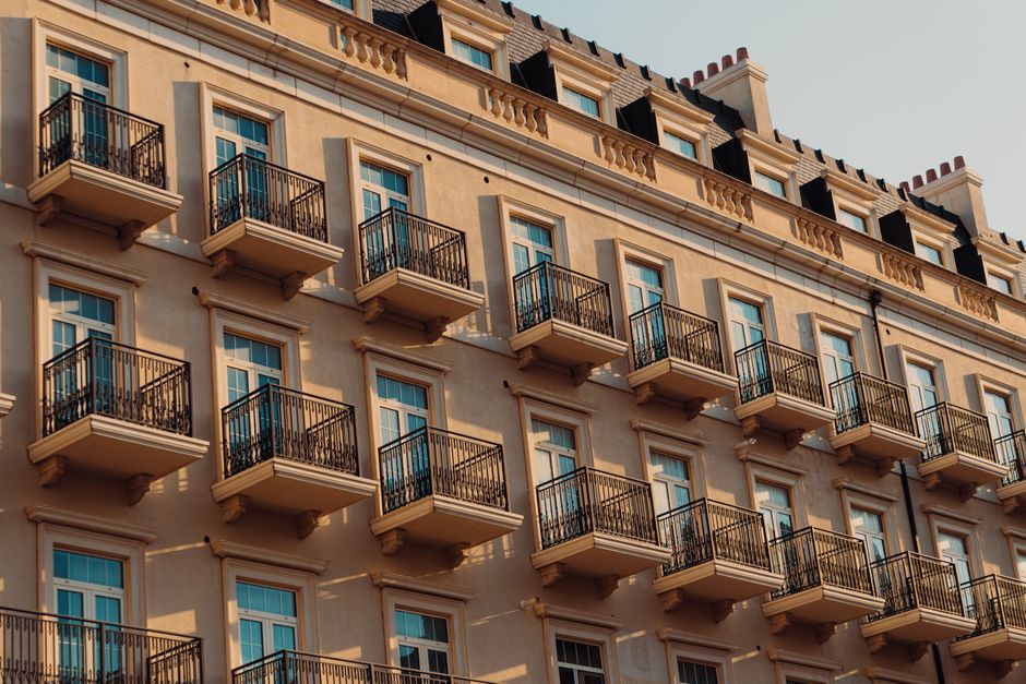 A stunning view of a classic residential building with balconies in Baku, Azerbaijan, during sunset.