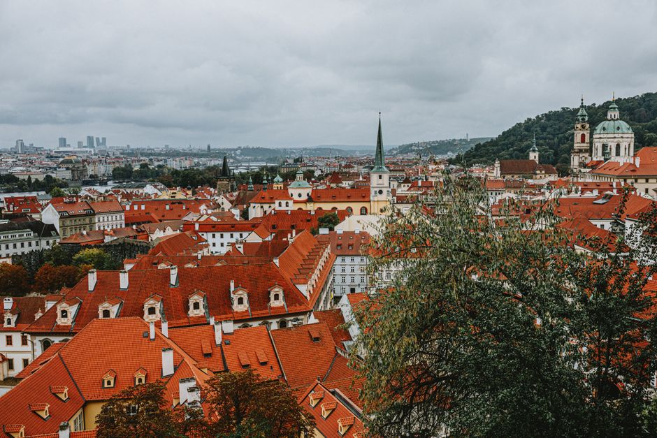 Stunning aerial view of Prague's iconic red rooftops and historic architecture.