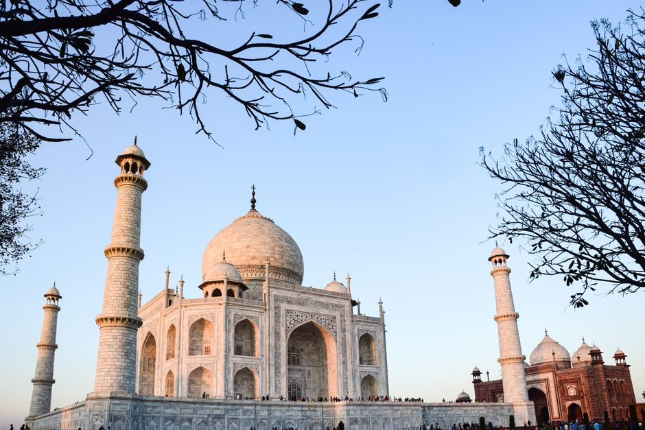 The Taj Mahal captured against a clear sky at dusk, showcasing its architectural beauty.