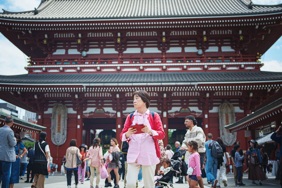 Bustling crowd in front of Senso-ji Temple in Tokyo's lively Asakusa district.