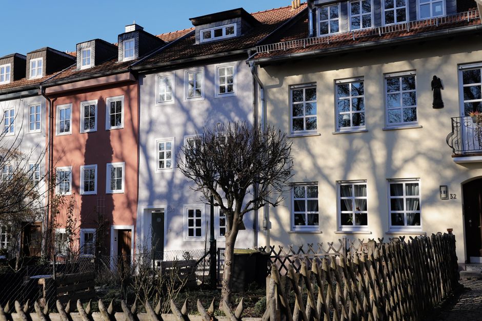 Colorful row houses in Fulda, Germany with shadows casting on a sunny day.