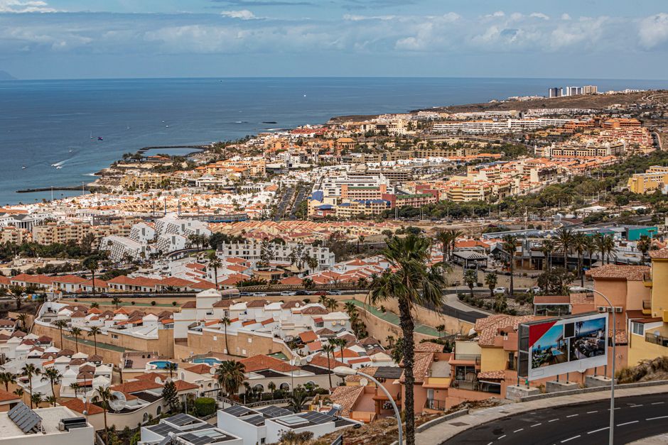 A beautiful aerial view of a vibrant coastal city with charming architecture and scenic sea views.