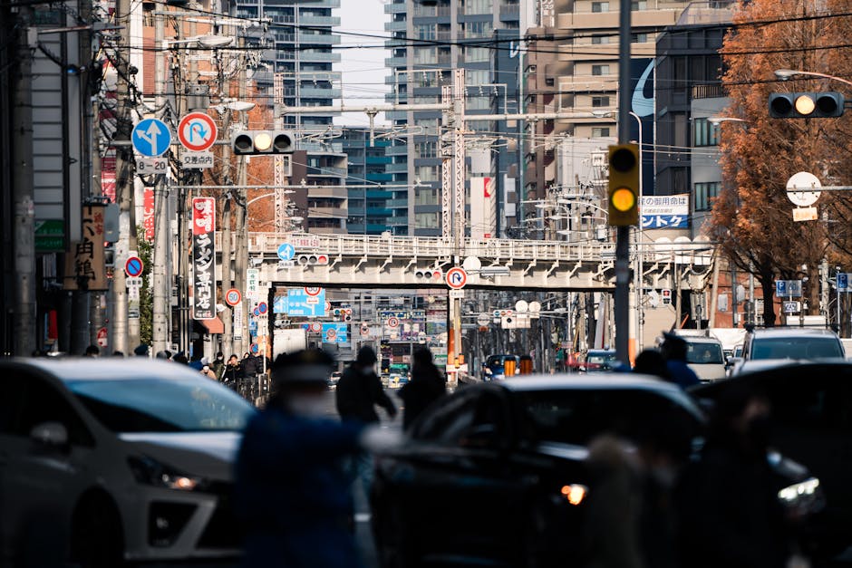 Explore the busy streets of downtown Osaka, Japan, a vibrant urban scene filled with people and vehicles.